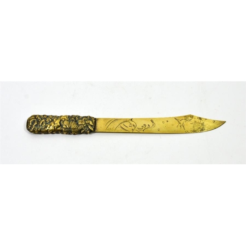 82 - A Japanese brass paper knife, the handle cast in relief with Samurai on coastal rocky outcrop with w... 