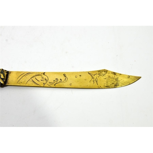 82 - A Japanese brass paper knife, the handle cast in relief with Samurai on coastal rocky outcrop with w... 