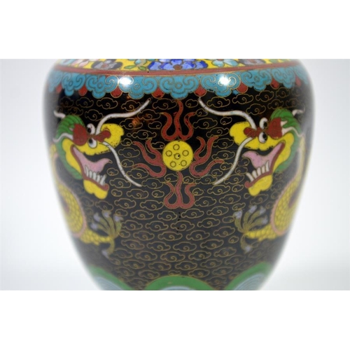 86 - A Chinese cloisonne enamelled vase, footed form, two five claw dragons flanking a flaming pearl, 26c... 