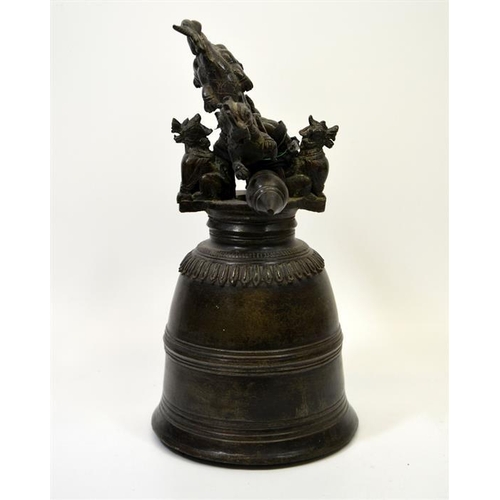 88 - A Chinese bronze bell, the support cast with dragons and dogs, 40cm high