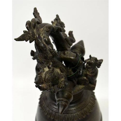 88 - A Chinese bronze bell, the support cast with dragons and dogs, 40cm high