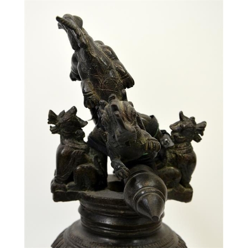 88 - A Chinese bronze bell, the support cast with dragons and dogs, 40cm high