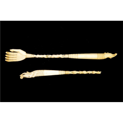 94 - Two 19th century tribal ivory back scratchers, carved elephants and bird totems, one with open hand,... 