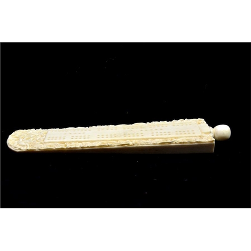 98 - λ A Chinese carved ivory cribbage board, 19th century, wedge form carved with dragons chasing a flam... 