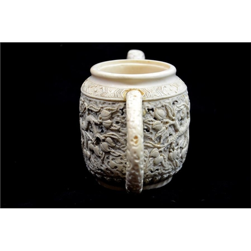 99 - λ A Chinese carved ivory teapot, 19th century, decorated to each side with a fruiting peach tree, be... 