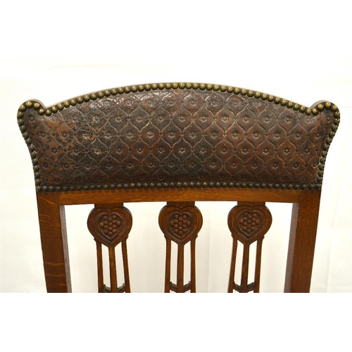 205 - A large arts and crafts oak library/gentleman's carved chair with original tooled leather, all brass... 