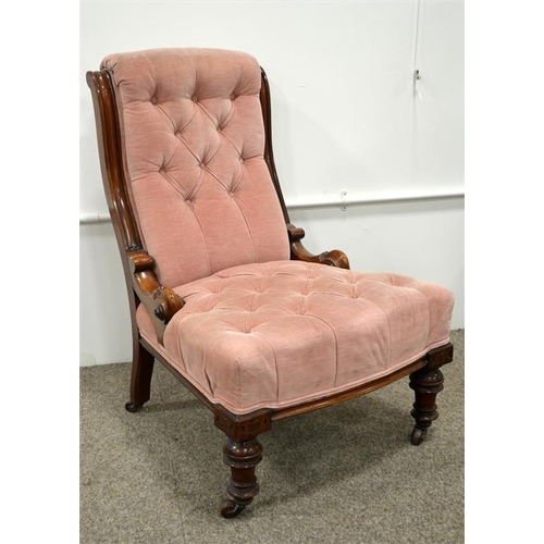 220 - A Victorian mahogany upholstered button back chair, on turned legs and ceramic casters