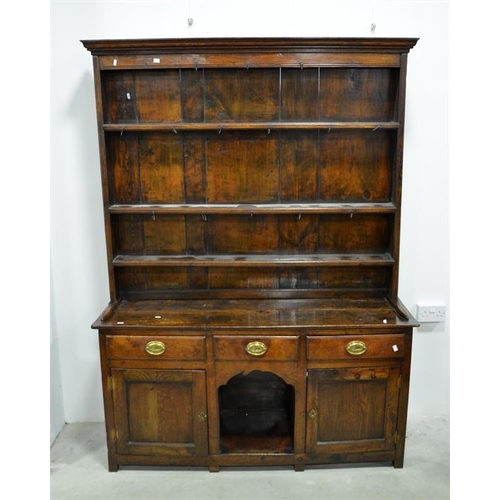 246 - A George III oak and pine dresser and rack, the three bay base with central kneehole flanked by cupb... 