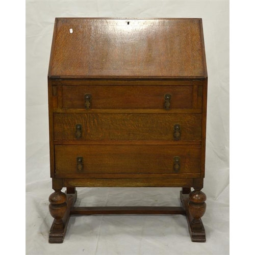 248 - A 1920s oak bureau, the fall front with mechanical supports, opening to reveal a pigeon holed interi... 