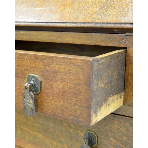 248 - A 1920s oak bureau, the fall front with mechanical supports, opening to reveal a pigeon holed interi... 