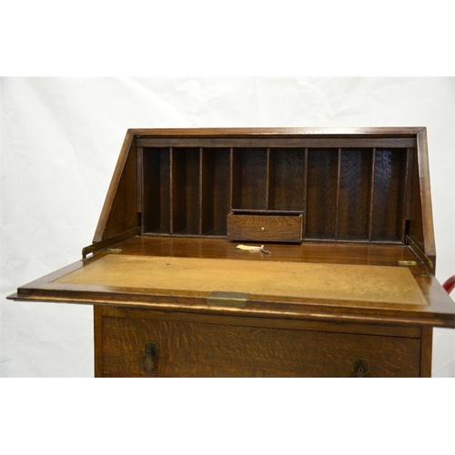 248 - A 1920s oak bureau, the fall front with mechanical supports, opening to reveal a pigeon holed interi... 