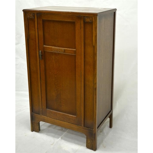 249 - A 1920s oak cupboard, of small proportions, single drawer, on bracket feet, carved Art Deco style pa... 