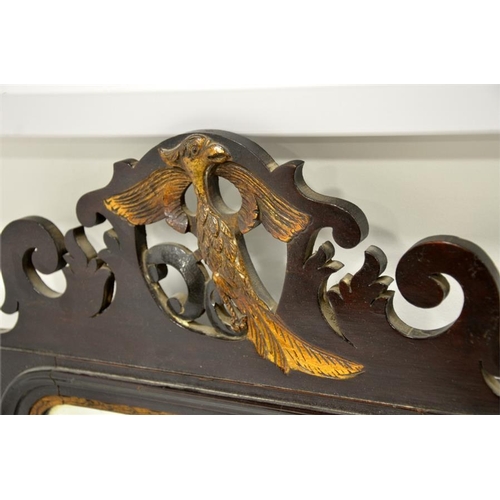 253 - A George II Chippendale style mahogany fretted mirror, the pediment carved with phoenix, the base wi... 