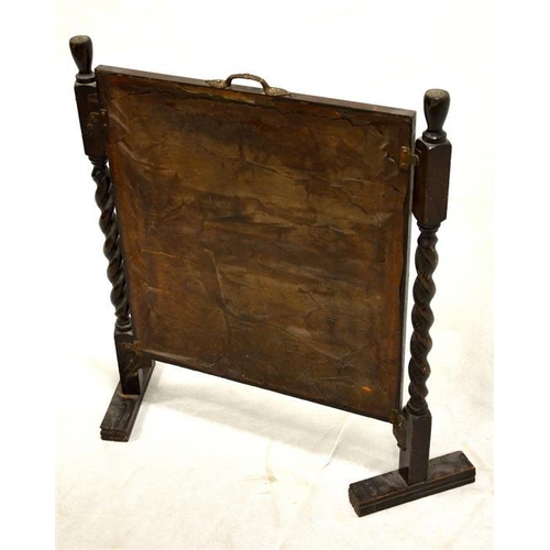 254 - A 1920s oak fire screen, barley twist supports and embroidered panel, 73cm high, 58cm wide