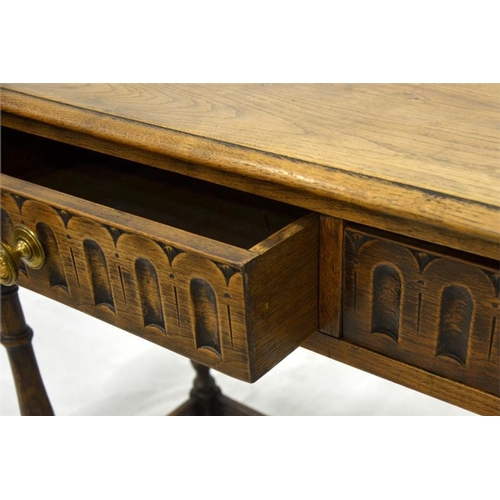 260 - An Old Charm style solid oak two drawer side table, jointed construction, relief moulded arcading an... 