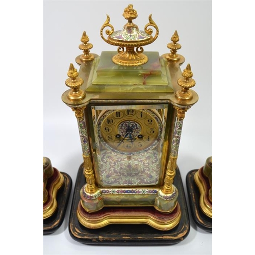 279 - A French champleve enamel, ormolu and onyx clock garniture, under glass domes, the Japy Freres movem... 