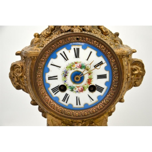 285 - A clock garniture with Sevres style porcelain plaques and roundel and the dial decorated with a flor... 