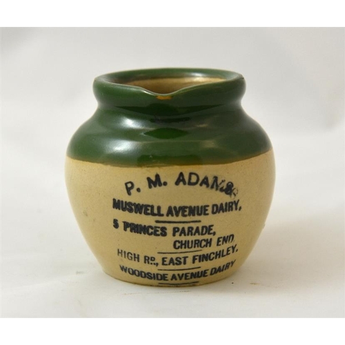 534 - A green top cream pot from P.M. Adams, Muswell Avenue Dairy, Finchley 7cm high.