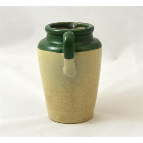 537 - A green top cream jug from White Heather Dairy Grayshott 12cm high.