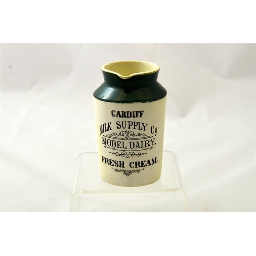 559 - A green top cream jug from the Cardiff Milk Supply Co Model Dairy 10.5cm high.