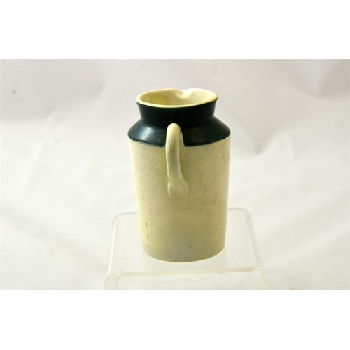 559 - A green top cream jug from the Cardiff Milk Supply Co Model Dairy 10.5cm high.