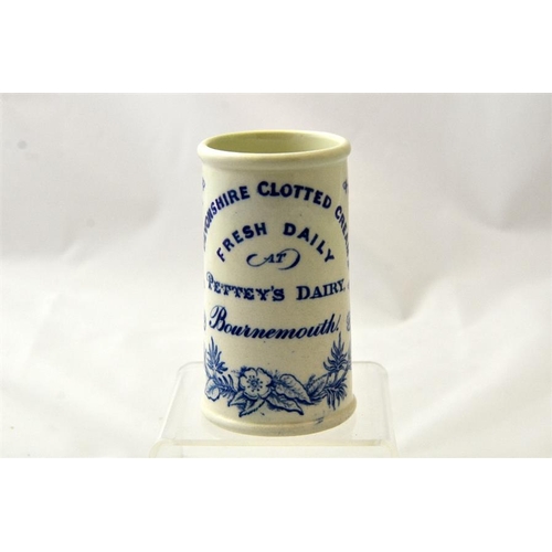 576 - A blue print cylinder cream pot from Pettey's Dairy, Bournemouth with floral border 12cm high.