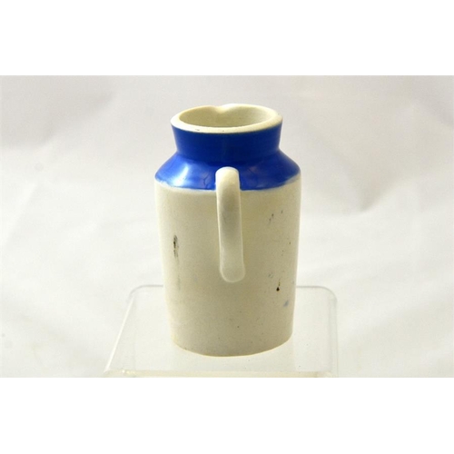 584 - A blue top cream jug from the Cardiff Milk Supply Co Model Dairy 10cm high.