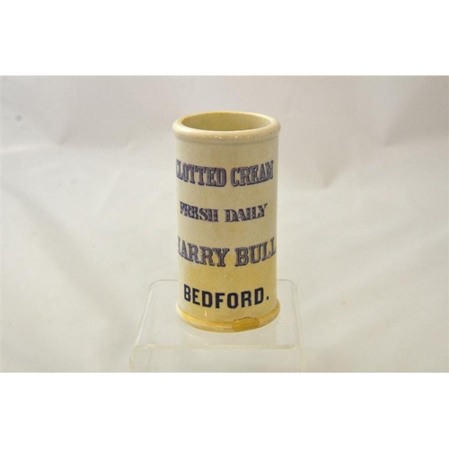 594 - A cylinder cream pot from Harry Bull Bedford in mauve print 12cm high.