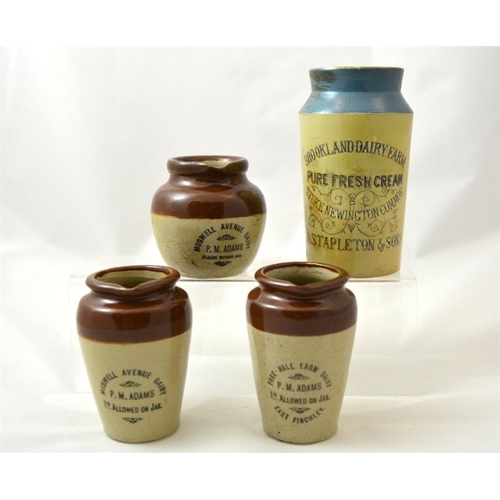 619 - Three cream pots from P.M. Adams, Muswell Avenue Dairy Finchley, together with a blue top pot from A... 