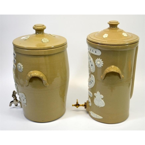 626 - Two stoneware advertising water filters, including the Atkins Filter Engineering & Water Softening C... 