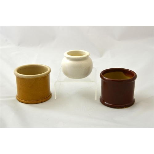 652 - Two cylinder cream pots in honey and brown glaze from James Skinner of Sidmouth, and Duke Dyre's Sto... 