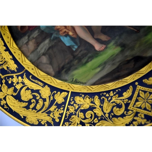 1595 - A Vienna syle plate, painted with an allegorical scene, cobalt border with raised paste gilding, sig... 