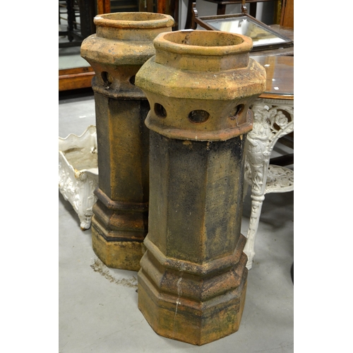 230 - A pair of Victorian terracotta chimney pots, octagonal section, tapered column form, 94cm high (2)