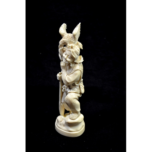 118 - λ A Japanese carved ivory okimono, Meiji, late 19th century, modelled as a hunter with gun and birds... 