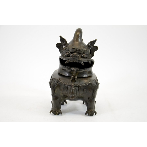 12 - A Chinese bronze censer in the form of a dog, Ming, the head hinged to the body, on four feet, 20cm ... 