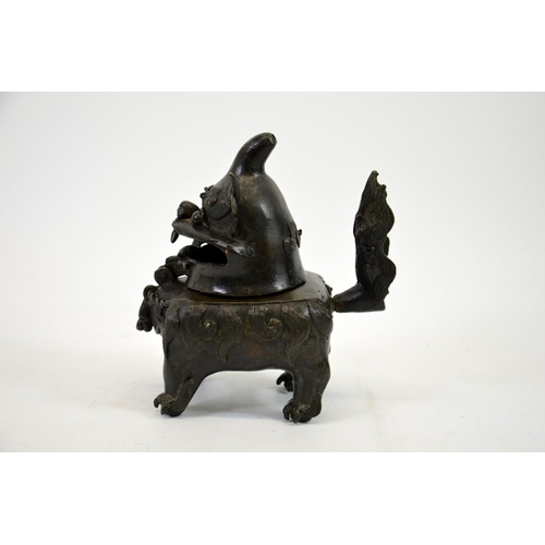 12 - A Chinese bronze censer in the form of a dog, Ming, the head hinged to the body, on four feet, 20cm ... 