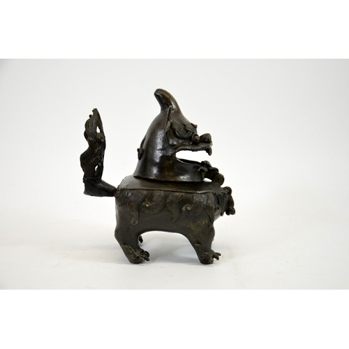 12 - A Chinese bronze censer in the form of a dog, Ming, the head hinged to the body, on four feet, 20cm ... 