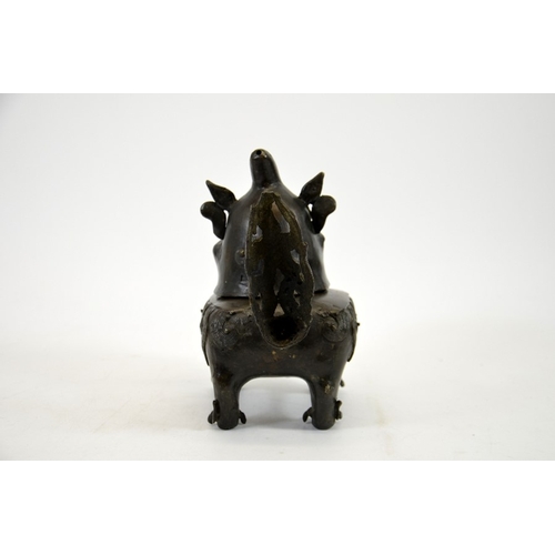 12 - A Chinese bronze censer in the form of a dog, Ming, the head hinged to the body, on four feet, 20cm ... 