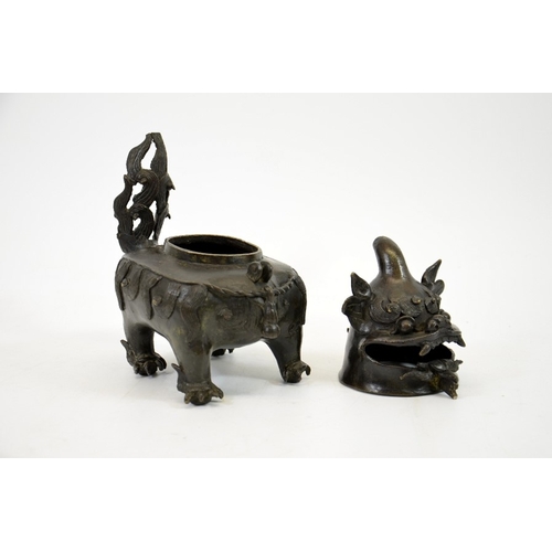 12 - A Chinese bronze censer in the form of a dog, Ming, the head hinged to the body, on four feet, 20cm ... 