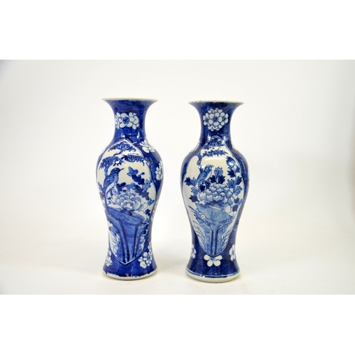 2 - A pair of Chinese blue and white vases, Kangxi mark, shouldered form, painted with panels of birds i... 