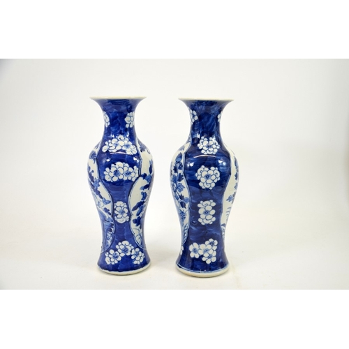 2 - A pair of Chinese blue and white vases, Kangxi mark, shouldered form, painted with panels of birds i... 