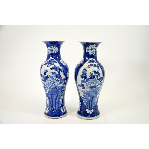 2 - A pair of Chinese blue and white vases, Kangxi mark, shouldered form, painted with panels of birds i... 