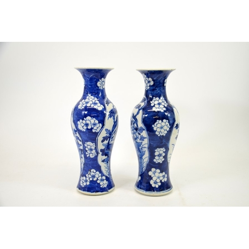 2 - A pair of Chinese blue and white vases, Kangxi mark, shouldered form, painted with panels of birds i... 