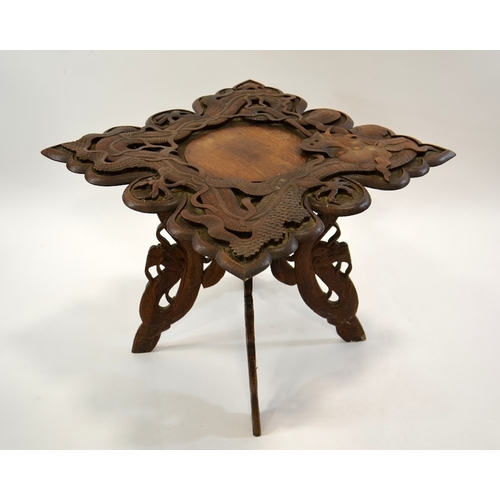 20 - A 19th century Oriental carved hardwood occasional table, modelled in open relief with scrolling Chi... 