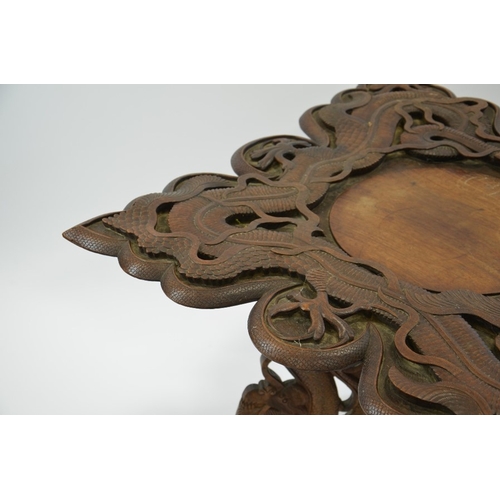 20 - A 19th century Oriental carved hardwood occasional table, modelled in open relief with scrolling Chi... 