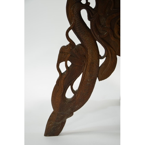 20 - A 19th century Oriental carved hardwood occasional table, modelled in open relief with scrolling Chi... 