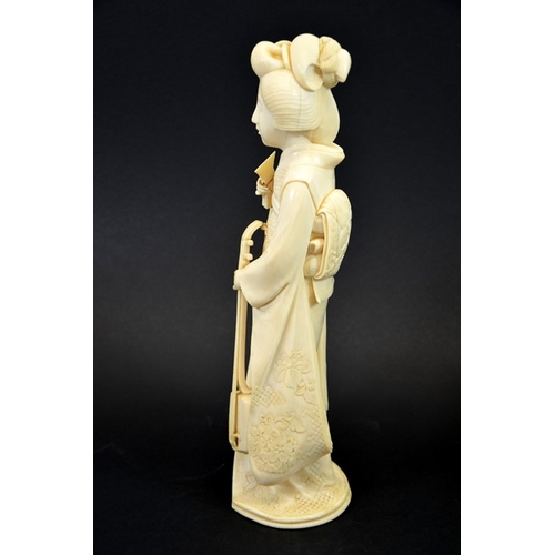 22 - λ A 19th century Japanese carved ivory okimono of a Geisha, Meiji, modelled with a stringed instrume... 