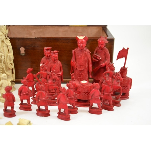 26 - λ A 19th century Chinese carved ivory chess set, white and red stained, one side modelled as the Imp... 