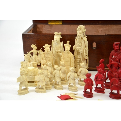 26 - λ A 19th century Chinese carved ivory chess set, white and red stained, one side modelled as the Imp... 