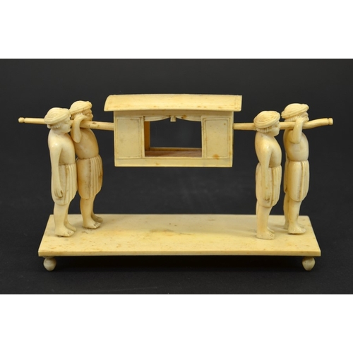 27 - λ A 19th century Indian ivory figure group of a palanquin being carried by four men, 15cm long, 8cm ... 